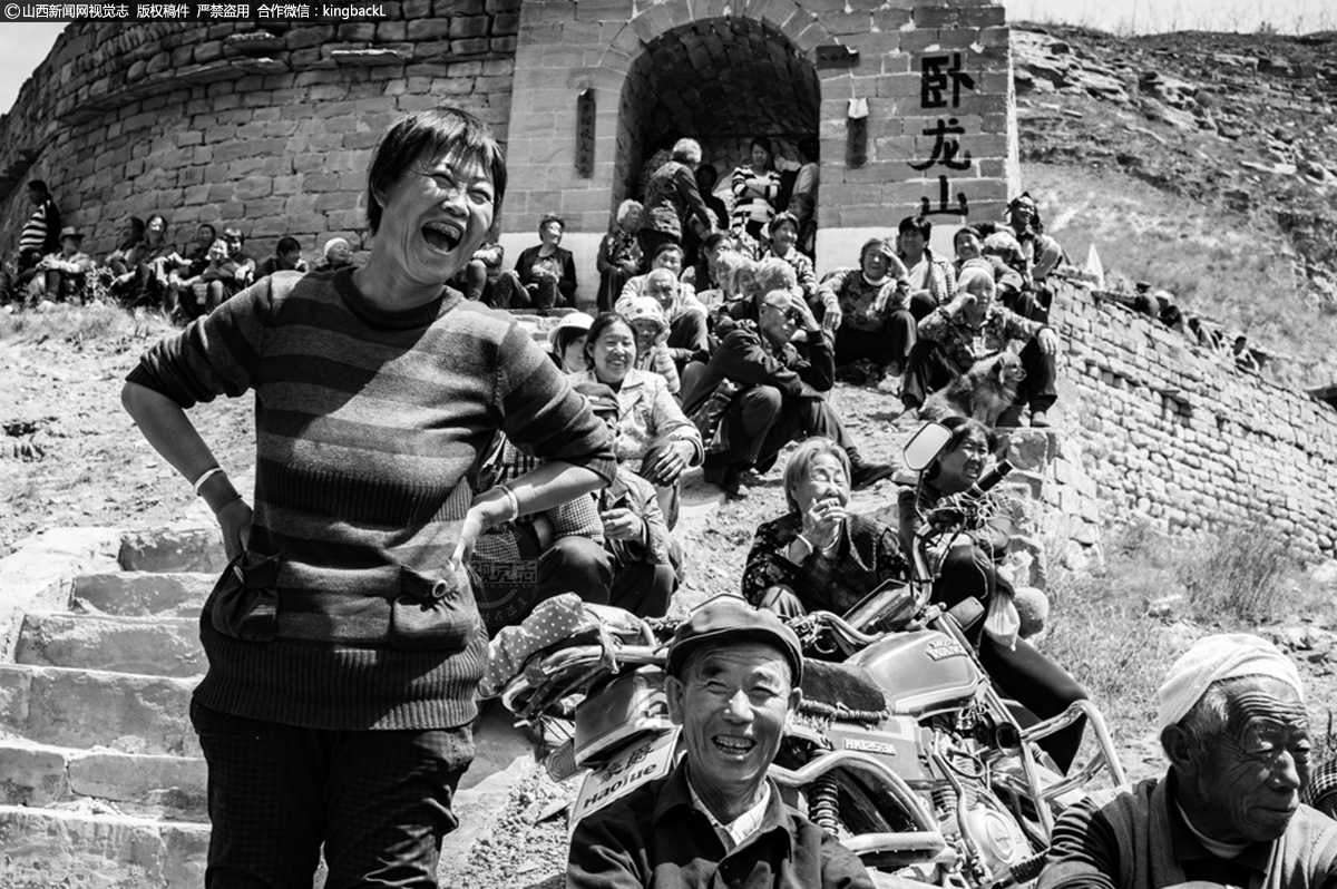      戏场里，多为拄棍的、背凳的老者，年轻的男男女女，挤来拥去，热闹非常。这是乡村的一角，却也寄托着人们对美好生活的向往，对家庭的期盼，对孩子未来的关注。