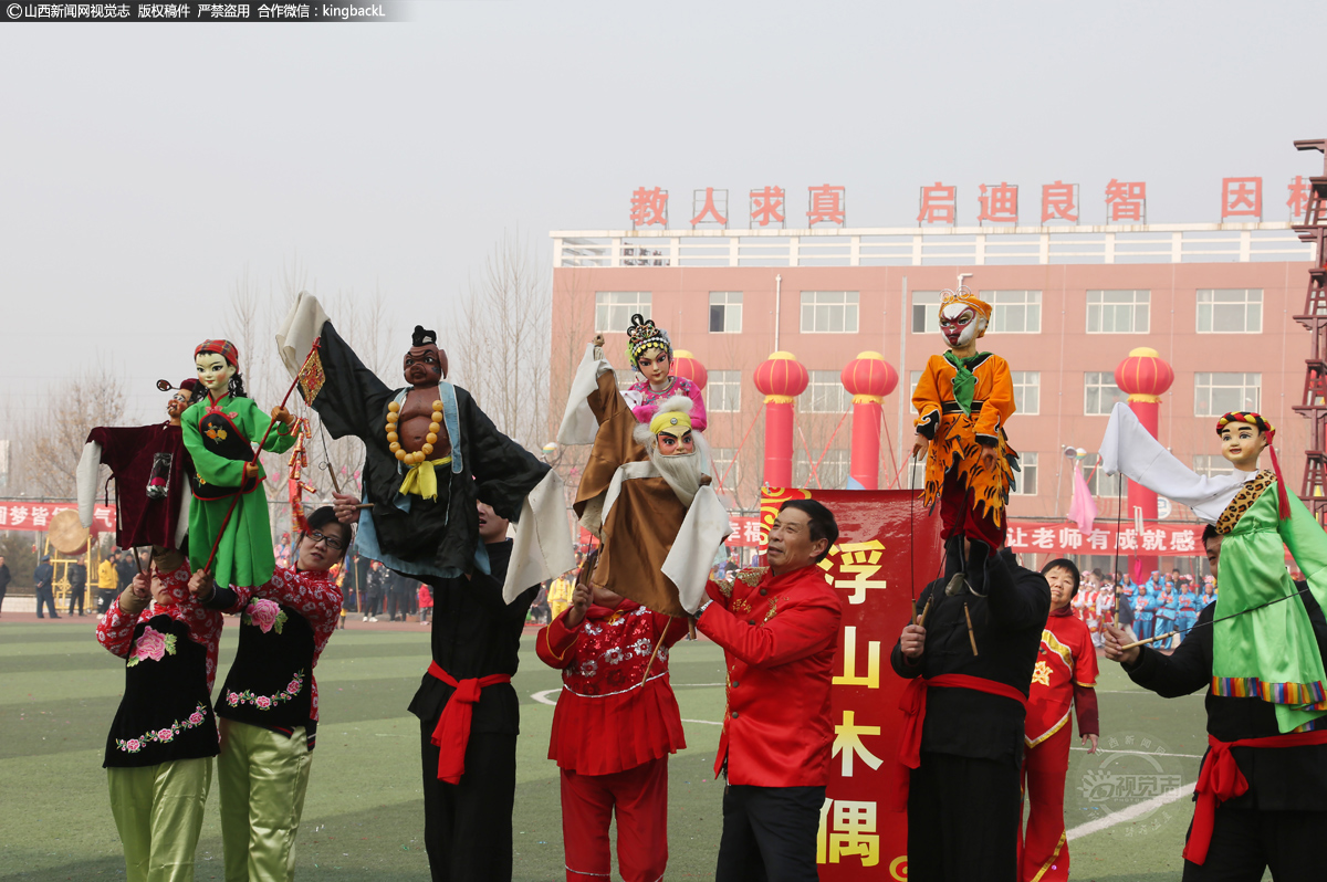      为了让更多学生喜爱这门艺术，使这一文化瑰宝代代相传，吴春安曾多次到学校、幼儿园进行木偶艺术表演。图为2019年正月，他带领女儿和徒儿走进某中学校园进行精彩表演。