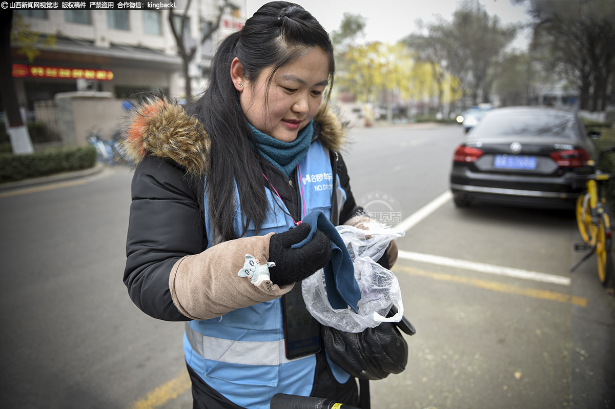      小张的包里常备着一块毛巾，用来清洁共享单车。她用塑料袋将毛巾包起来。这样既可以保持毛巾的湿润，同时还能避免包和其他物品被弄湿。