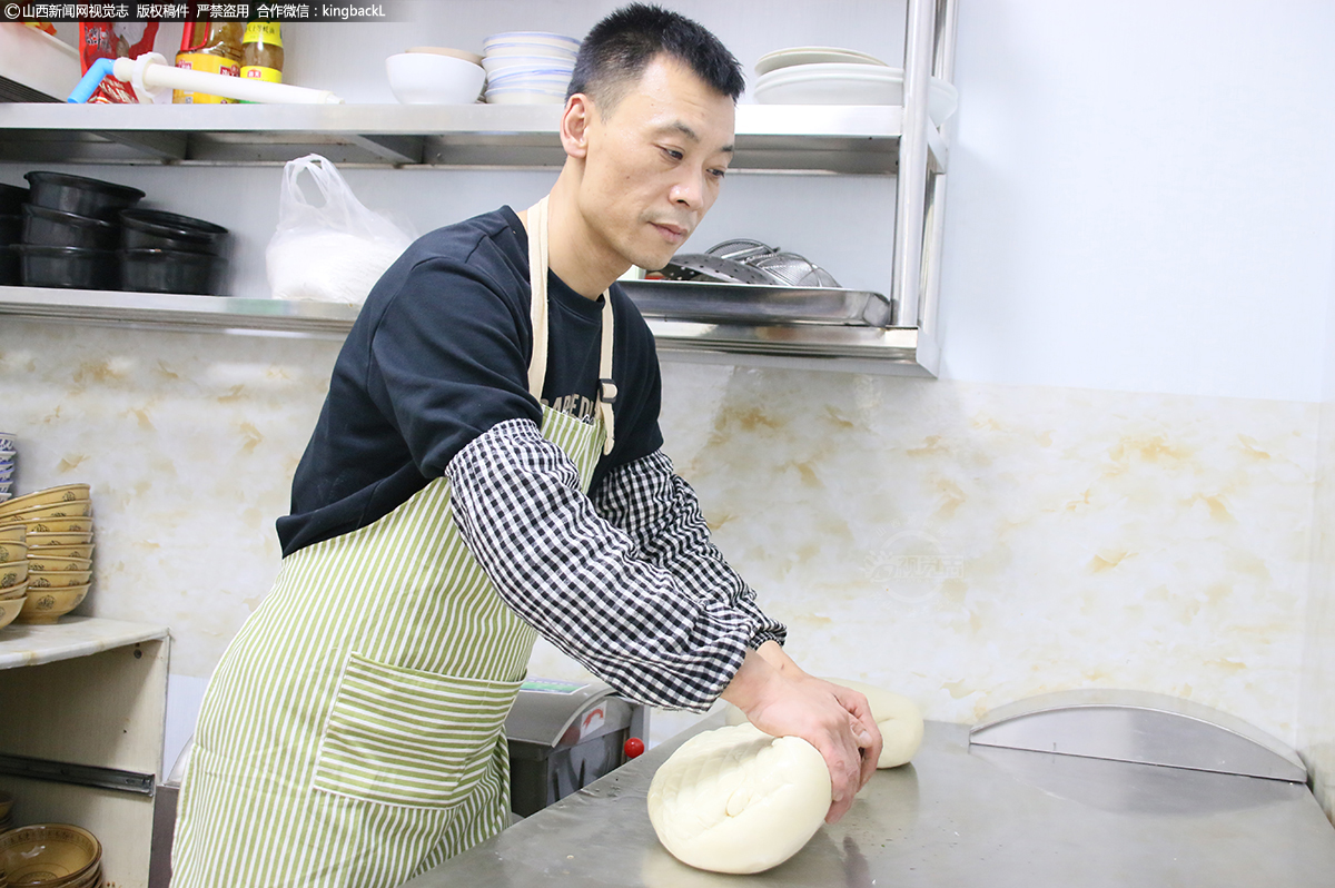      一方案板是段志勇的工作台，面馆面粉采用的都是晋南黄河沿岸小麦。段志勇揉面功夫已经炉火纯青，每天要卖出100多碗6元小面。